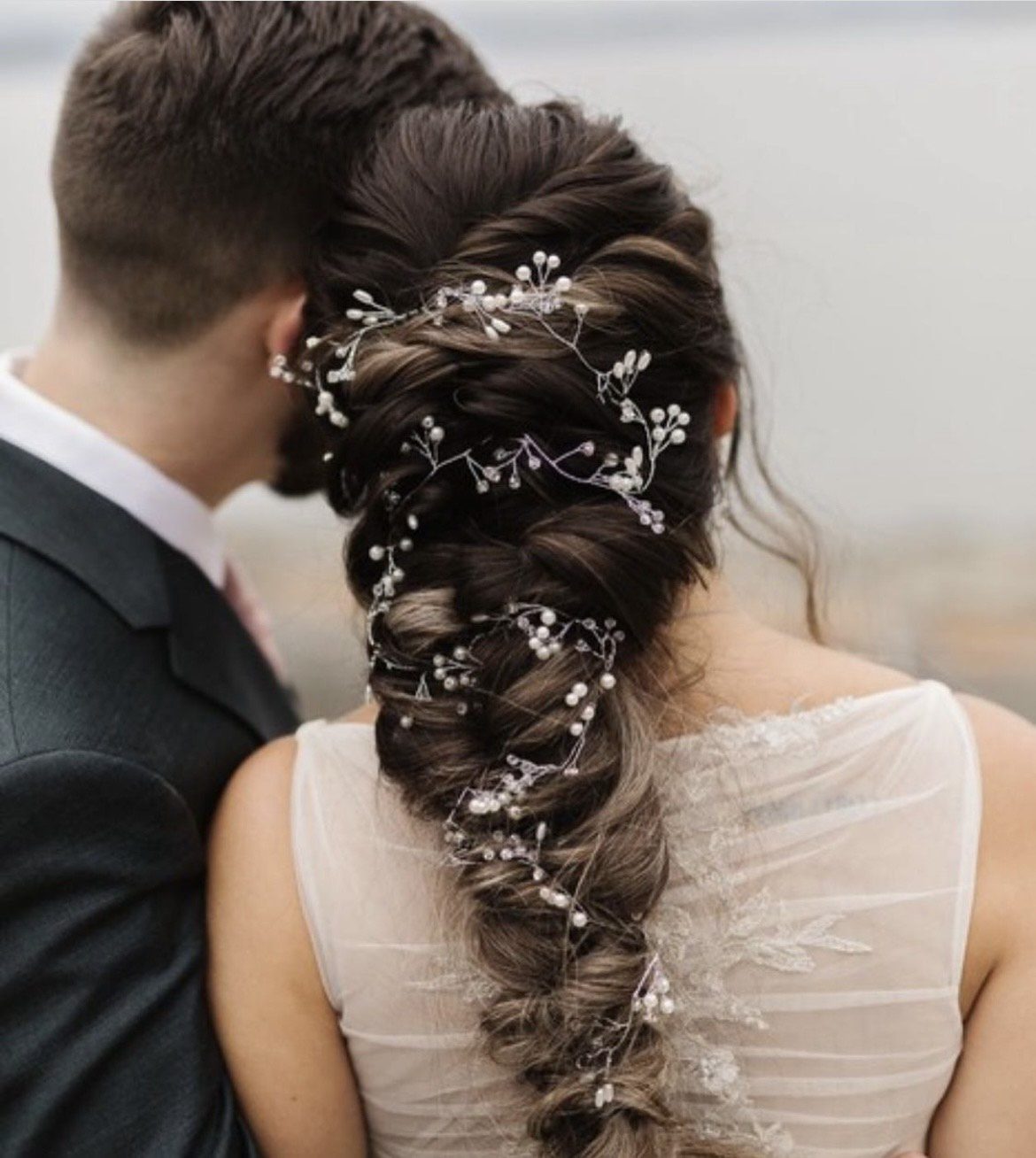 bride with long braid and pearls