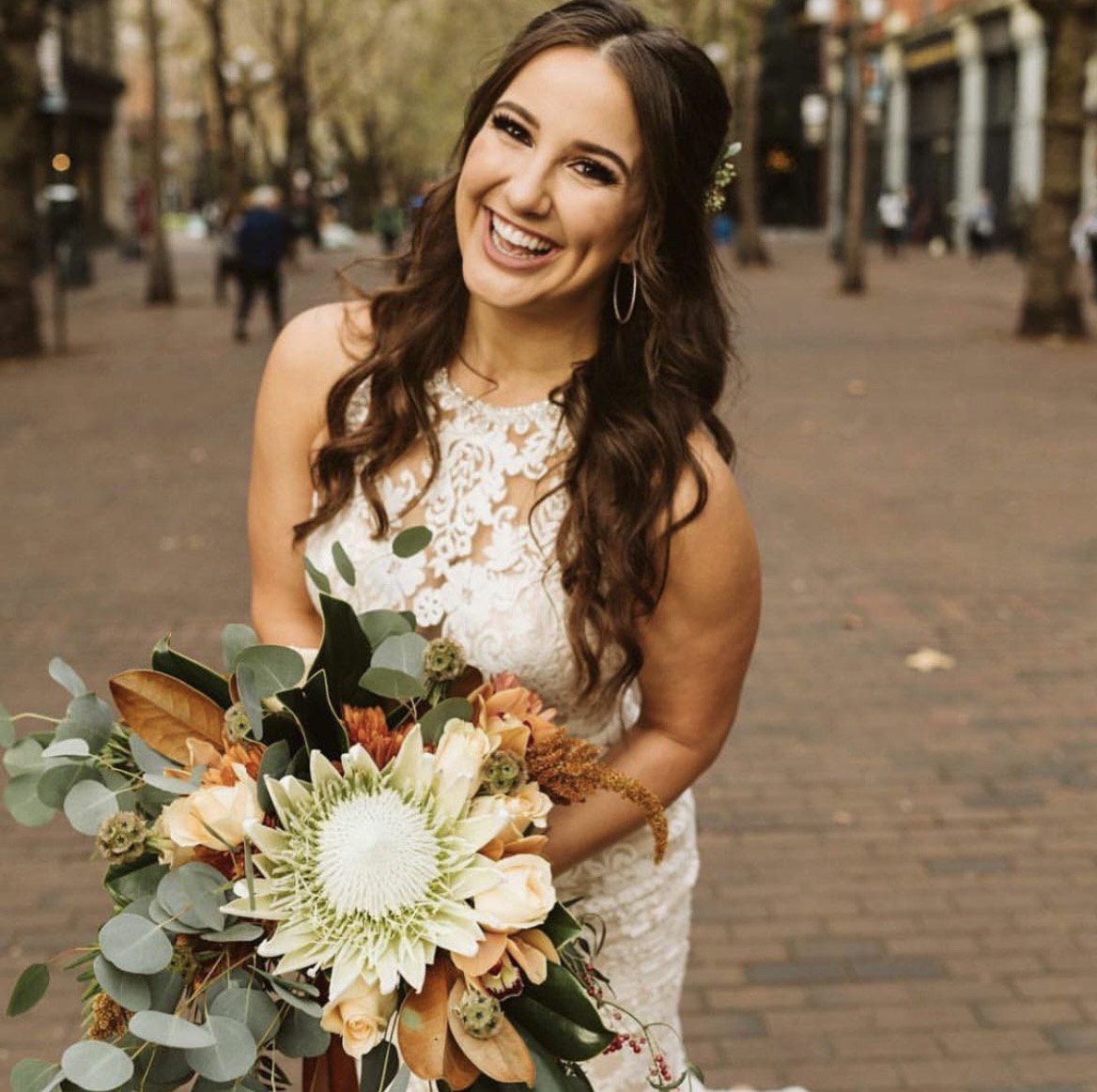 bride smiling with half up do